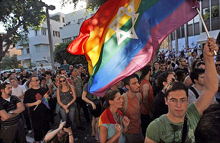 lesbian couple is kissing out on the street.