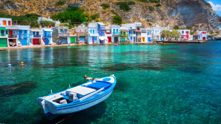 Прочут със своите сгради със сини покриви и бели каменни стени Санторини